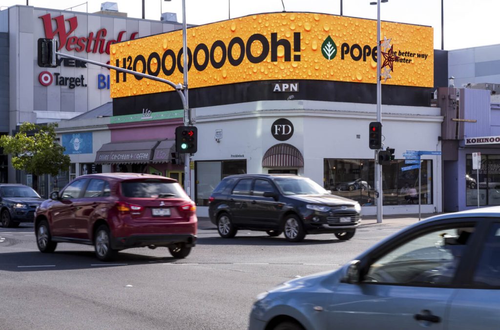 large corner digital billboard on a street